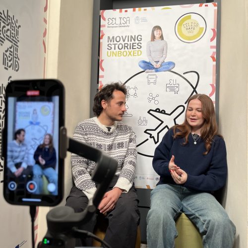 EELISA student Interviewing other at the Moving Stories Unboxed corner at SNS
